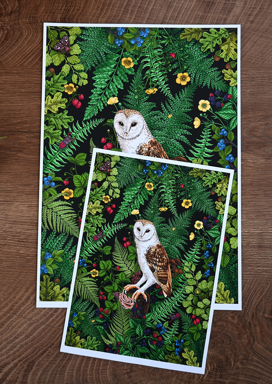 Two prints in A4 and A5 size with an owl illustration on a green leafy background, placed on a wooden surface.