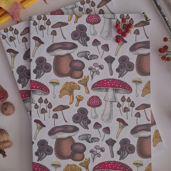 video showing a hand-made notebook with hand-painted mushrooms pattern print on the cover