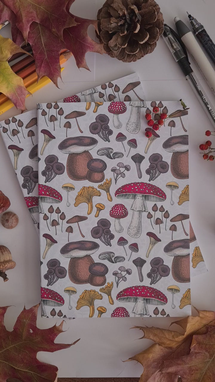 video showing a hand-made notebook with hand-painted mushrooms pattern print on the cover