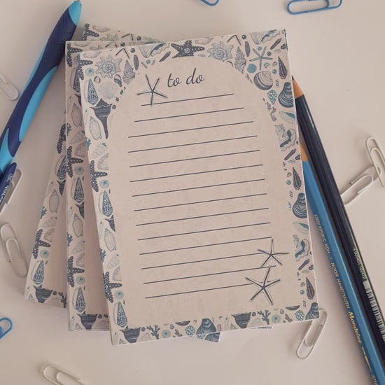 viodeo of notepads ilustrated with hand-painted Seashells pattern