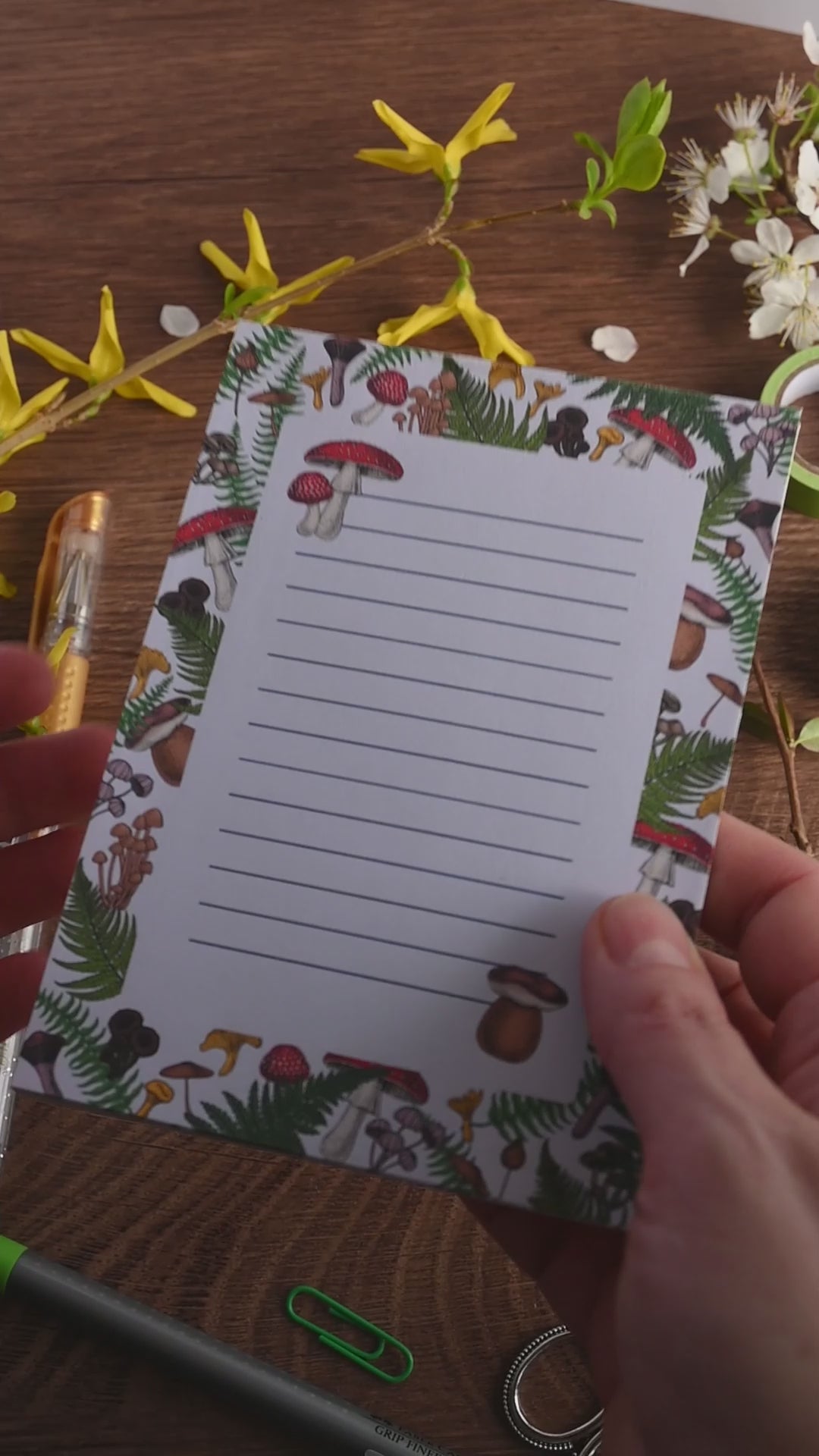 video featuring a notepad illustrated with wild mushrooms and fern