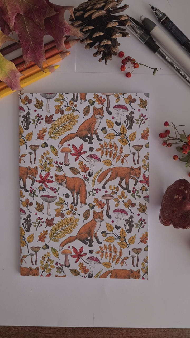 video showing a hand-made notebook with hand-painted Autumn Foxes  pattern print on the cover