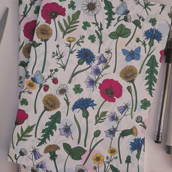 video showing a hand-made notebook with hand-painted Wildflowers pattern print on the cover