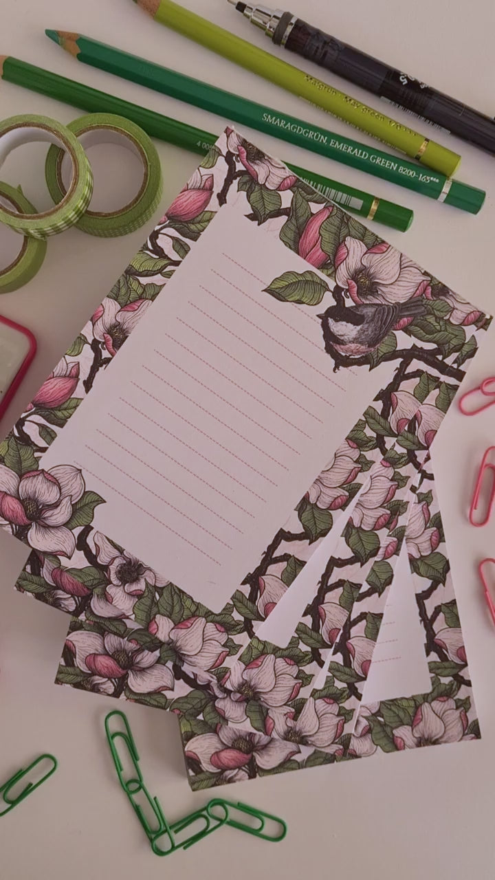 video of a hand-made notepad illustrated with Magnolia and Chickadee birds 